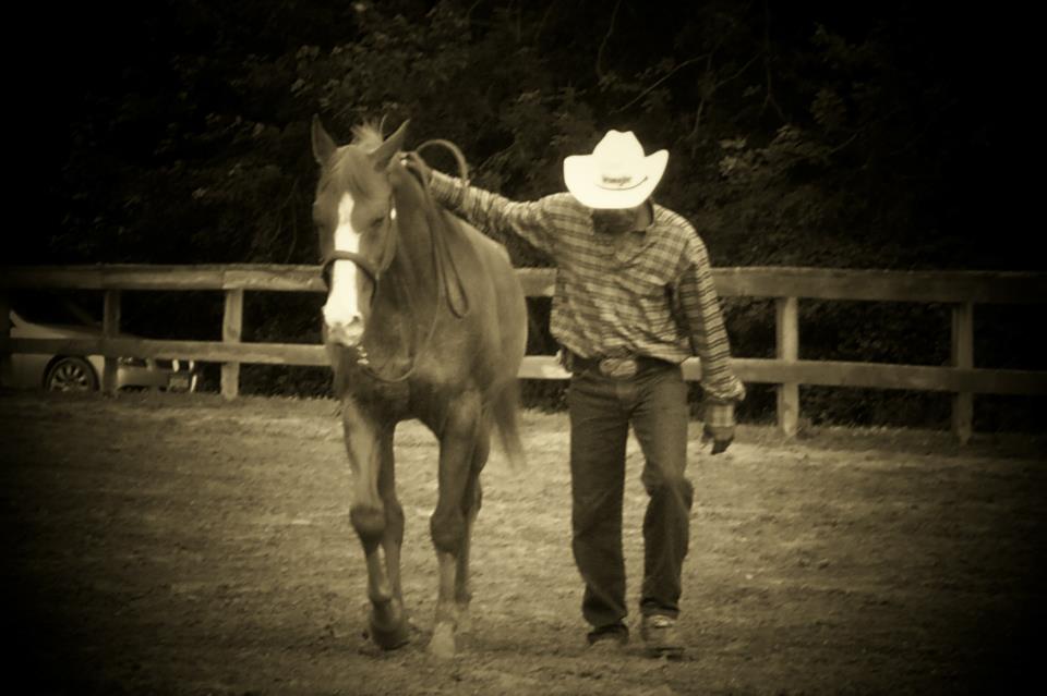 Ozzie Morris leading a horse through the Wind Chaser arena
